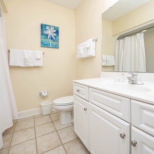 Enjoy a relaxing shower after a day of adventure in this guest bath with stylish accents and fluffy towels