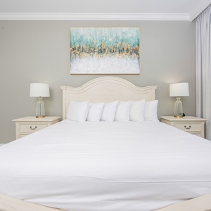 Sleep peacefully in the master bedroom, surrounded by soft linens and serene decor inspired by coastal colors