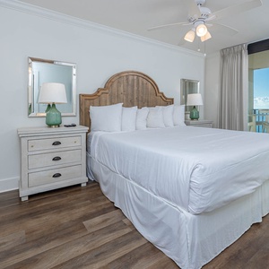 Serene master bedroom featuring a king bed, stylish decor, and beachfront balcony access