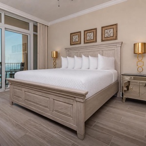 Retreat to the king master suite with cozy bedding and drift off to the sound of the waves from the balcony