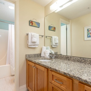 Enjoy the master bathroom featuring a granite countertop, ample storage, and a relaxing tub-shower combination