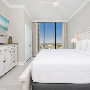 Rest in this guest bedroom featuring a king bed, stylish decor, and large windows offering beautiful views