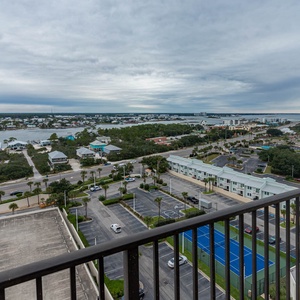 Expansive view of the surrounding area from the master balcony, showcasing lush greenery and nearby tennis courts