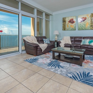 Relax in the inviting living area, featuring plush seating, queen sofa sleeper, and stunning beach views