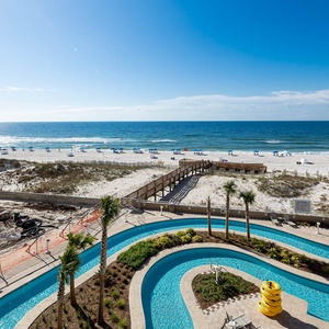 Discover the inviting pool area with relaxing lazy rivers and thrilling waterslides, right on the beach