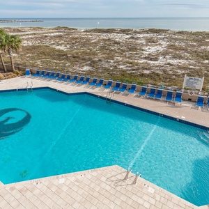 Dive into relaxation at this inviting pool area, complete with lounge chairs and easy access to the beach boardwalk