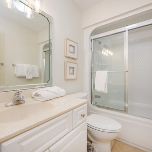 Refresh and rejuvenate in this guest bathroom, enjoying fluffy towels and a relaxing retreat after beach adventures