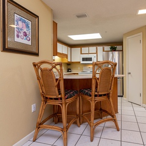 Gather around the stylish bar stools at the kitchen counter, perfect for casual meals and morning coffee