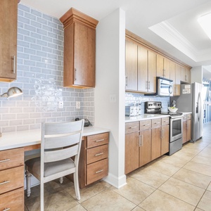 This kitchen features cozy workspace with a view, comfortable seating, a desk lamp, and complimentary WiFi during your stay