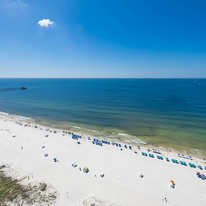 Breathe in the fresh air while enjoying expansive views from your balcony overlooking the beach and tranquil waters