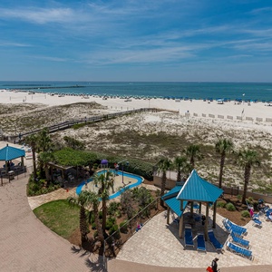 Take a refreshing dip in the pool while enjoying views of the beach and vibrant lounge areas nearby