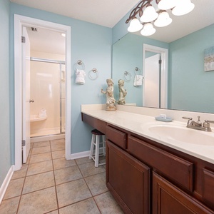 Brighten your day in this master bath featuring a spacious vanity, decorative accents, and a convenient walk-in shower