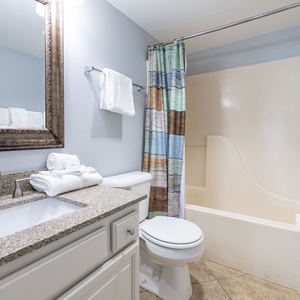 Refresh in the master bath after a day at the beach with a soothing tub or relaxing shower