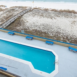 Take a refreshing dip in the pool surrounded by lounge chairs, just steps from the beach and scenic views
