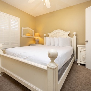 Retreat to this charming guest bedroom featuring a queen bed, soft lighting, and tasteful decor for a restful night's sleep