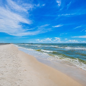 Discover stunning beachfront views with gentle waves lapping at the shore at the Lighthouse in Gulf Shores