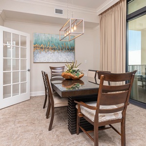 This dining area features a stylish table, elegant lighting, and a beautiful view, perfect for memorable meals