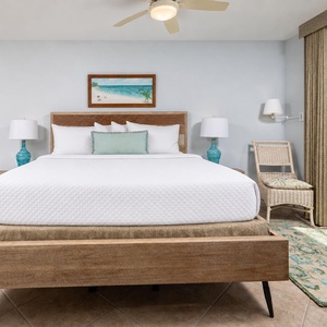 Retreat to the king master suite with cozy bedding and drift off to the sound of the coast from the balcony