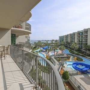 Bask in warm breezes while savoring views of the bay, lush pool area, lazy river, and fun waterslide