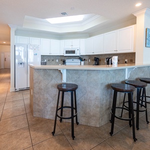 Wake up with morning coffee at the breakfast bar and get ready for a beach day in this stylish space