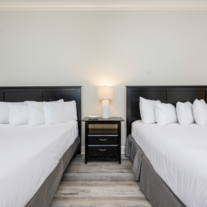 Rest and recharge in soft queen beds, where every night invites comfort and peaceful dreams after a day at the beach