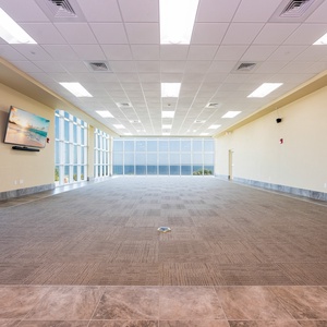 A comfortable meeting room featuring a large flat-screen TV and stunning Gulf views, perfect for gathering, presentations, or group meetings