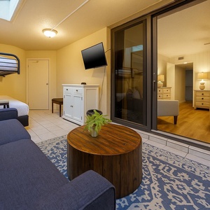 Cozy patio area featuring a twin/full bunk bed, TV, and rustic coffee table