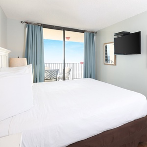 Relax in this master suite with a plush king bed, soft lighting, and a view that invites you to unwind