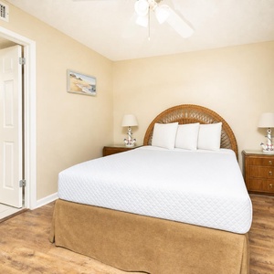 Soft pillows rest on the queen bed in the guest suite where you unwind after a day of coastal fun