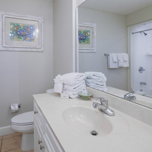 Experience rejuvenation in this bright bathroom with fresh towels and a spacious vanity, perfect for your daily routines