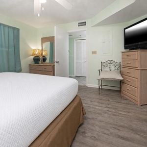 Relax in this inviting bedroom, featuring a spacious king bed, stylish decor, and a TV