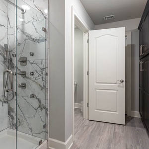 Step into the frameless shower with body sprays, a handheld wand, and begin your day refreshed