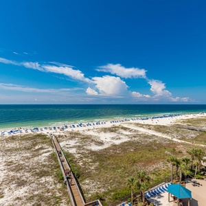 Gaze at the inviting beach scene with colorful umbrellas and gentle waves, perfect for a relaxing getaway