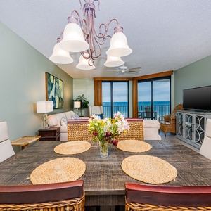 Enjoy meals at the dining table with a view, surrounded by comfortable seating and coastal decor
