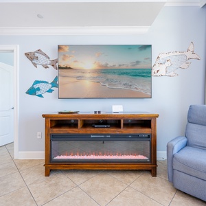 A cozy recliner invites you to sink in and enjoy a movie night by the warming electric fireplace in the living room