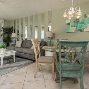 Unwind in the stylish living area featuring comfortable seating, a dining space, and beautiful coastal decor
