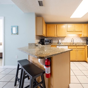 Prepare meals at the kitchen island, featuring ample counter space and a stylish backsplash