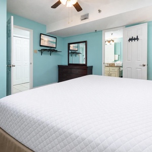 Plush king bed invites restful nights after a day of sun and shore adventures in this master suite
