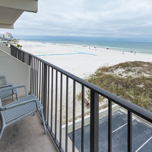 Enjoy a serene view of the pristine beach from the cozy balcony with comfortable seating