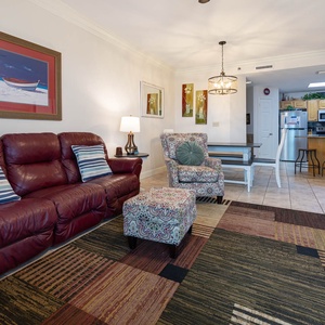 Relax in the inviting living area with plush seating, colorful decor, and easy access to the dining space