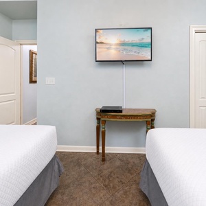 The guest suite with two queens invites you to rest deeply while your favorite shows play on the wall TV