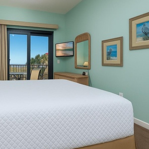 Sink into the soft king bed, enjoying coastal views from your window while planning your next beach day