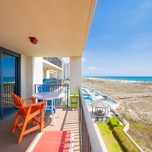 Relax on your balcony in colorful chairs, savoring the coastal views and gentle breezes of beach life