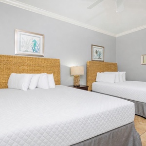 Cozy queen guest suite with plush bedding, coastal decor, and stylish accents