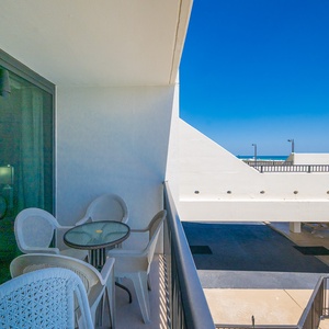 Enjoy your morning coffee on your balcony, taking in the inviting beach views and vibrant coastal vibe