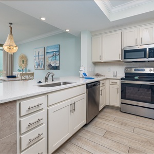 Prepare meals in this kitchen with elegant cabinetry, stainless appliances, and spacious countertops