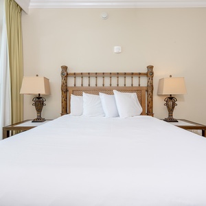 Sleep peacefully in soft queen bedding, waking to serene coastal views form your guest suite balcony