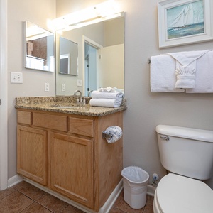 Accessible from the living space and bedroom, the bathroom provides ample towels and stylish decor