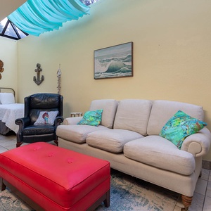 Vibrant coastal decor complements the indoor master patio with three twin beds and beach artwork