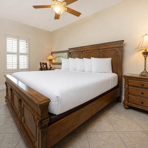 Warm wood furnishings complement the inviting king bed, while natural light brightens this serene guest bedroom